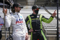 JR Hildebrand, left, talks with Charlie Kimball during practice for the Indianapolis 500 auto race at Indianapolis Motor Speedway in Indianapolis, Thursday, May 20, 2021. (AP Photo/Michael Conroy)