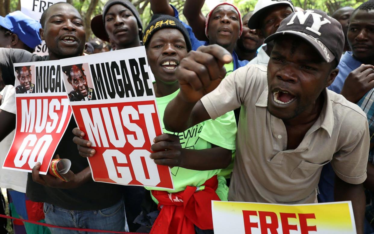 Protesters call for Robert Mugabe to step down before an impeachment hearing begins in the Zimbabwean parliament - REUTERS