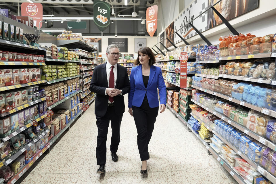 Labour Party leader Keir Starmer, left, and shadow chancellor Rachel Reeves to a supermarket while on the general election campaign trail, in Wiltshire, England, Wednesday, June 19, 2024. (Stefan Rousseau/PA via AP)