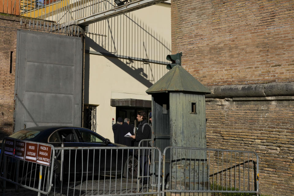 People enter the Vatican, Saturday, Dec. 16, 2023. The once-powerful Cardinal Angelo Becciu and nine other people are to learn their fate Saturday when a Vatican tribunal hands down verdicts in a complicated financial trial that has aired the tiny city state's dirty laundry and tested its justice system. (AP Photo/Andrew Medichini)