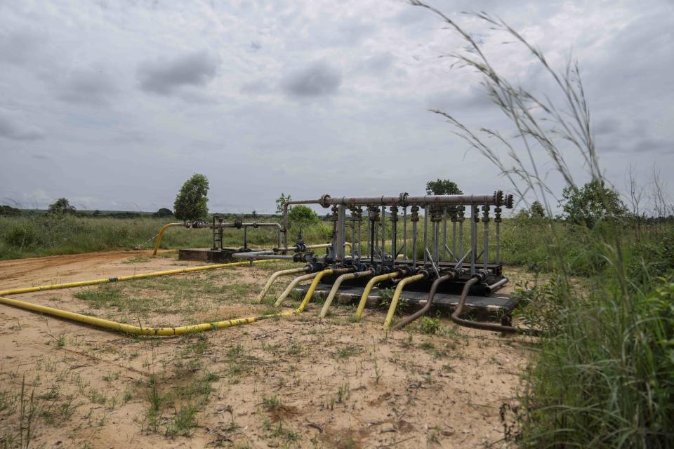 Pipes extend from an oil drilling structure near the village of Kinkazi, outside Moanda, Democratic Republic of the Congo, Sunday, Dec. 24, 2023. (AP Photo/Mosa'ab Elshamy)