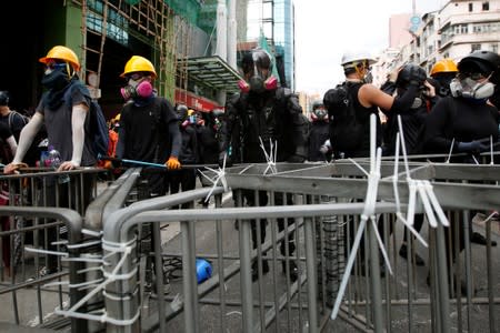 Ah Lung and other protesters hold the barricade near Sham Shui Po police station in Hong Kong