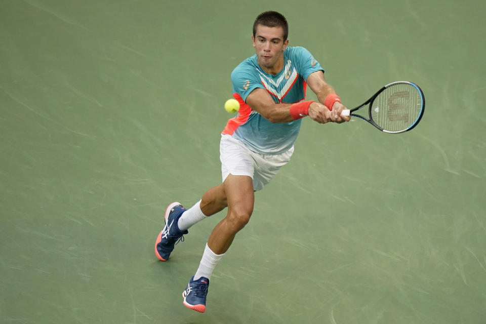Borna Coric, of Croatia, returns a shot to Jordan Thompson, of Australia, during the fourth round of the US Open tennis championships, Sunday, Sept. 6, 2020, in New York. (AP Photo/Frank Franklin II)