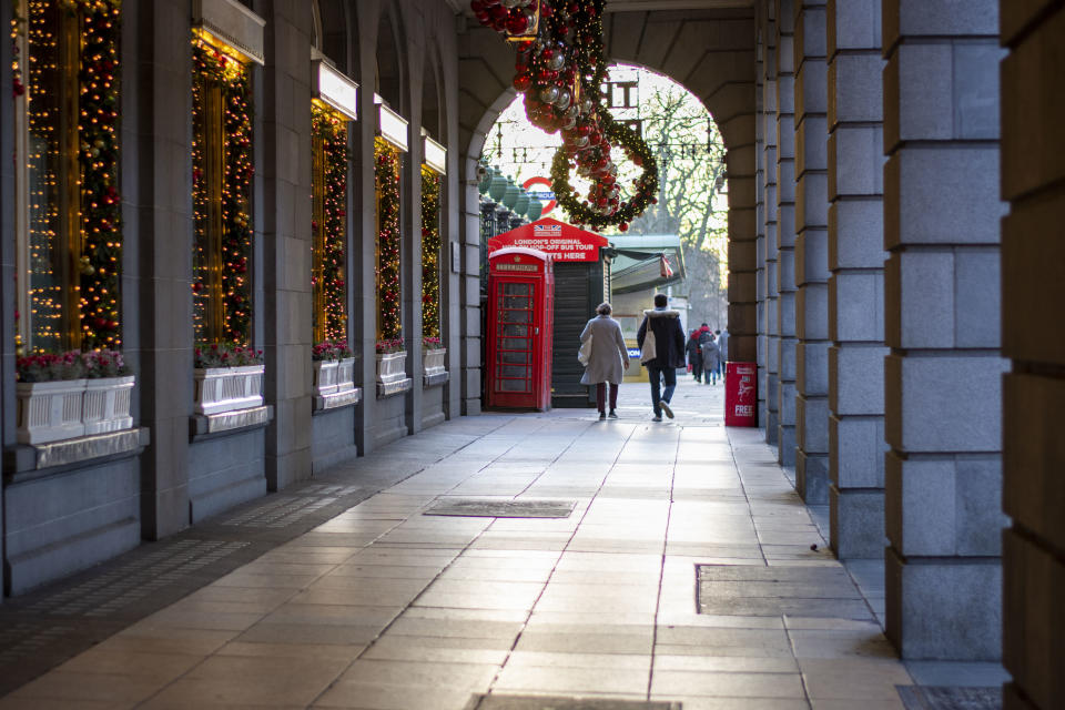  A couple walks past Christmas decorations at the Ritz London.
Under tier four restrictions, pubs and restaurants will close, as well as �non-essential� retail. (Photo by Pietro Recchia / SOPA Images/Sipa USA) 