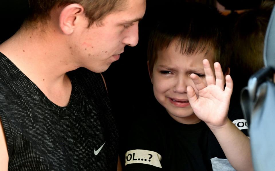 A little boy says goodbye to his mother before being evacuated from the city of Sloviansk to the city of Dnipro, on July 6, 2022 - Miguel Medina/ AFP