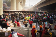 DELHI, INDIA - 2021/01/26: Protesters remove a truck trolley from the road during the demonstration. Farmers protesting against agricultural reforms breached barricades and clashed with police in the capital on the India's 72nd Republic Day. The police fired tear gas to restrain them, shortly after a convoy of tractors trundled through the Delhi's outskirts. (Photo by Manish Rajput/SOPA Images/LightRocket via Getty Images)