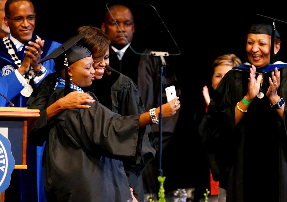 Senior class president Nicole A. Tinson takes a selfie with first lady Michelle Obama during Dillard University's commencement ceremony in New Orleans, Saturday, May 10, 2014. (AP Photo/Jonathan Bachman)