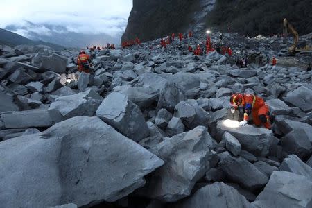 Rescue workers search for survivors at the site of a landslide that occurred in Xinmo Village, Mao County, Sichuan province, China June 24, 2017. REUTERS/Stringer