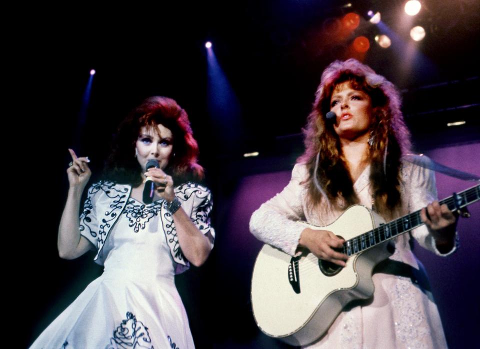 Mother Naomi, left, and daughter Wynonna of The Judds kick off their performance at Starwood Amphitheatre on Aug. 19, 1989, with the bluesy hit tune "I Know Where I'm Going." The Judds topped a bill that also included stars Dwight Yoakam and Clint Black.