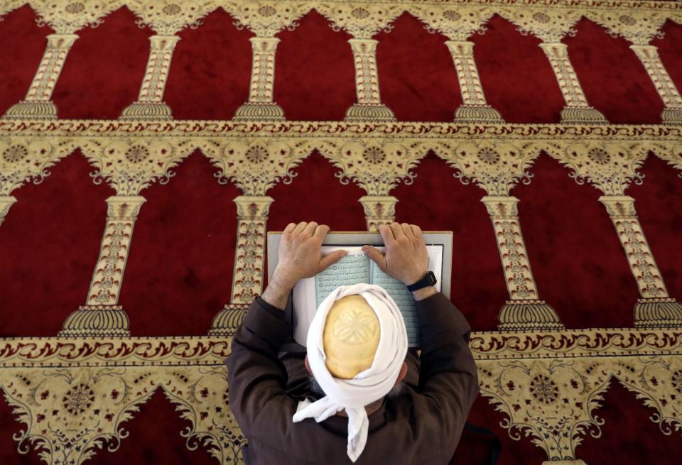 <p>A Palestinian man reads the Quran in al-Aqsa Mosque, on the compound known to Muslims as al-Haram al-Sharif and to Jews as Temple Mount, in Jerusalem’s Old City during the holy month of Ramadan, May 28, 2017. (Ammar Awad/Reurters) </p>