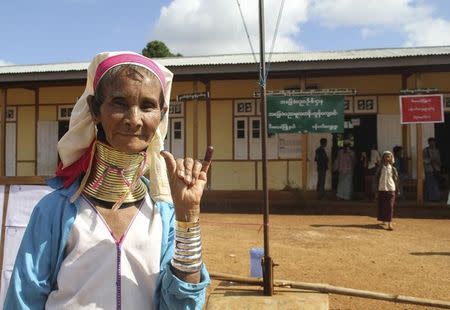 A Kayan woman, from one of Myanamr's ethnic minority groups, shows her ink-stained finger after she voted, in front of a polling station in Panpet village, Demoso township, Kayah state November 8, 2015. REUTERS/Nay Lynn Thike