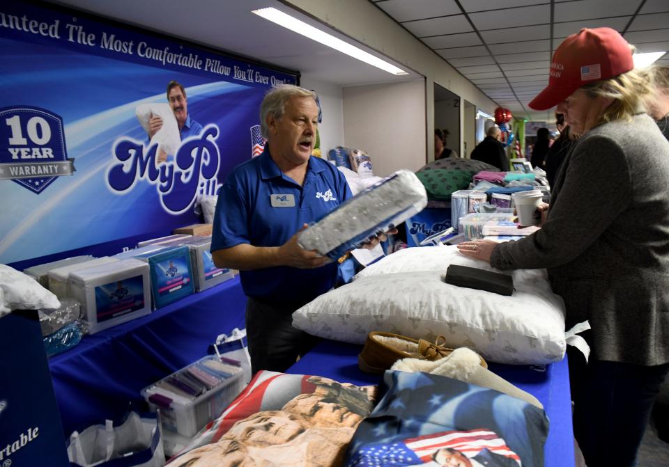 Henry Sitko of Pennsylvania sells My Pillow pillows, one of the vendors at ReAwaken America Tour at Trinity Gospel Temple in Canton.