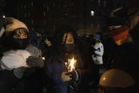 People prepare candles during a candlelight vigil outside the apartment building which suffered the city's deadliest fire in three decades, in the Bronx on Tuesday, Jan. 11, 2022, in New York. (AP Photo/Yuki Iwamura)