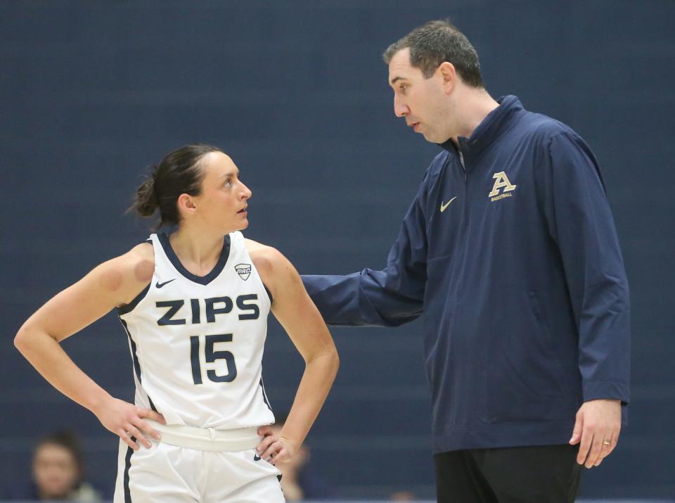 University of Akron's Morgan Haney talks with coach Ryan Gensler during the first quarter of a game against Ball State on Jan. 6 in Akron.