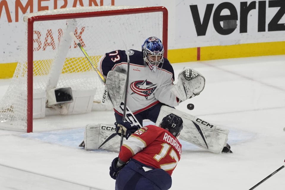 Columbus Blue Jackets goaltender Jet Greaves (73) stops a shot on goal by Florida Panthers center Evan Rodrigues (17) during the first period of an NHL hockey game, Thursday, April 11, 2024, in Sunrise, Fla. (AP Photo/Marta Lavandier)