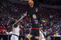 San Diego State forward Adryana Quezada (32) shoots over UNLV center Desi-Rae Young (23) during the first half of an NCAA college basketball game for the championship of the Mountain West women's tournament Wednesday, March 13, 2024, in Las Vegas. (AP Photo/Ian Maule)
