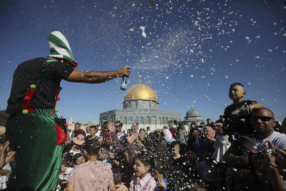 Palestinains celebrate the Islamic holiday of Eid al-Adha.in front of the Dome of then Rock shrine in Jerusalem, Sunday, Aug 11, 2019. (AP Photo/Mahmoud Illean)