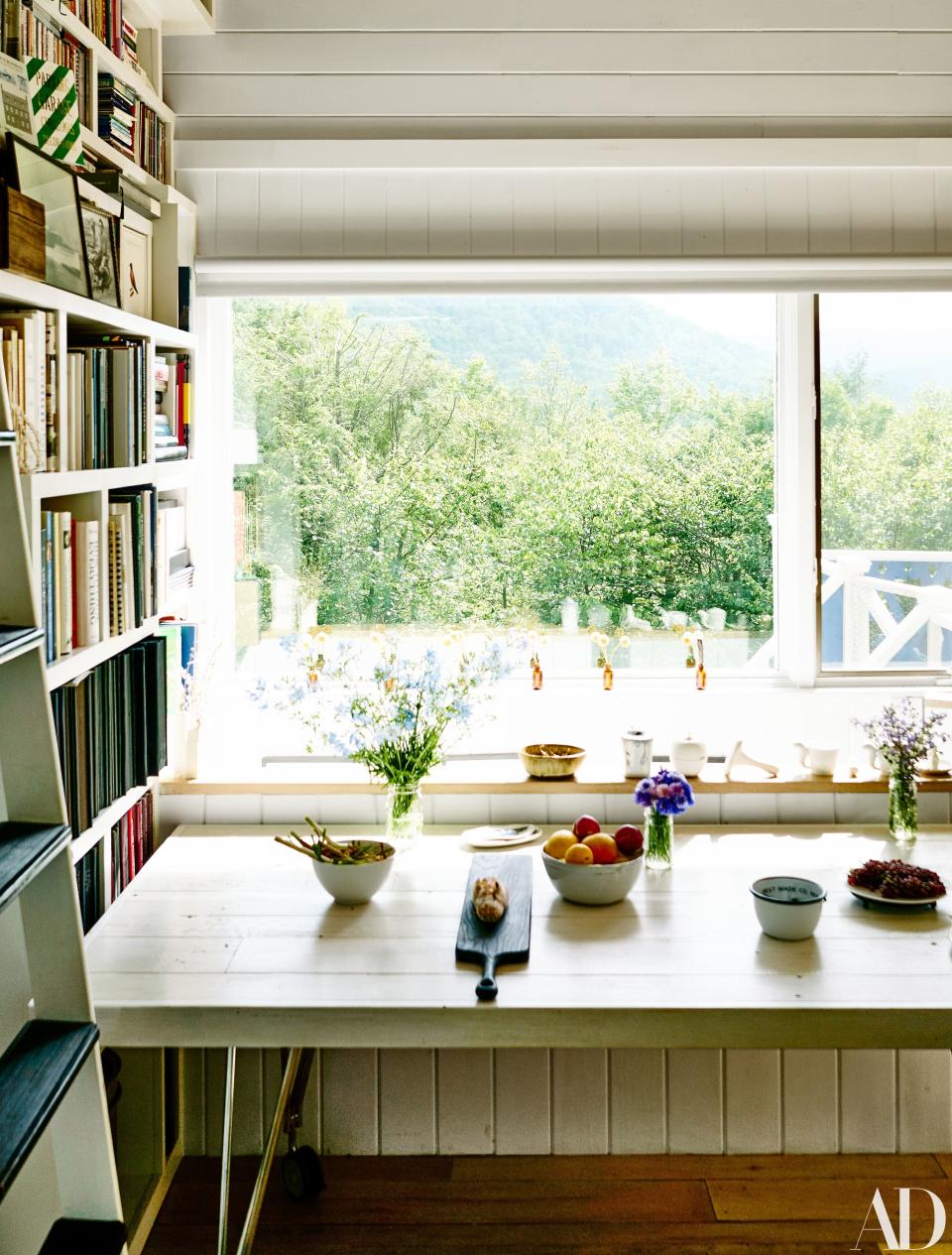 Guests now bunk in the original cabin, where the kitchen and living room overlook the Catskills.