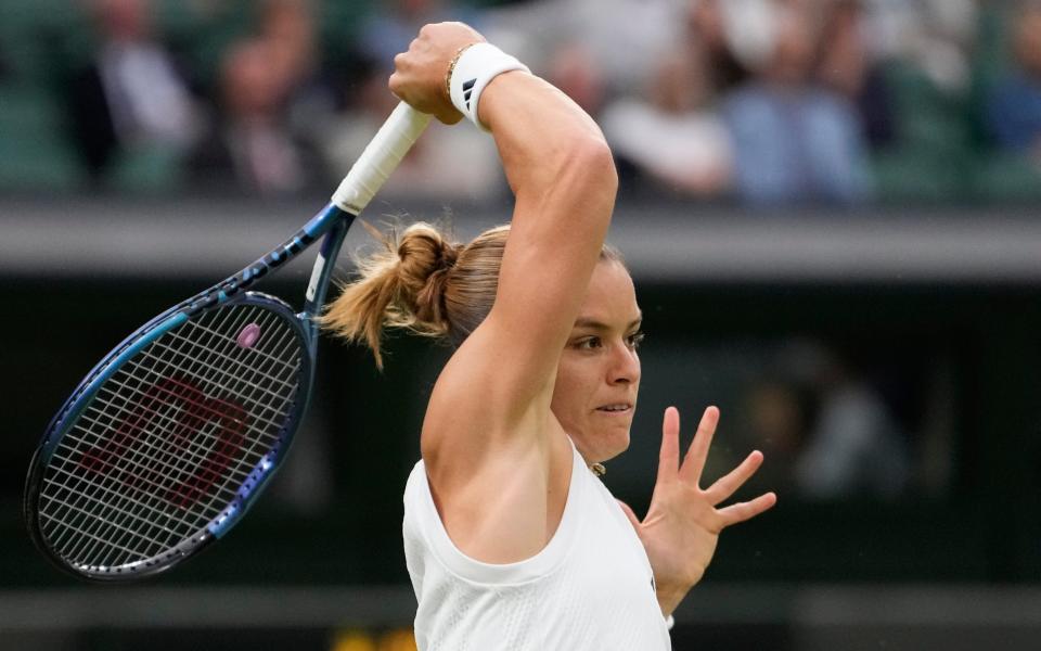 Maria Sakkari of Greece plays a forehand return to Emma Raducanu of Britain during their third round match at the Wimbledon tennis championships in London, Friday, July 5, 2024