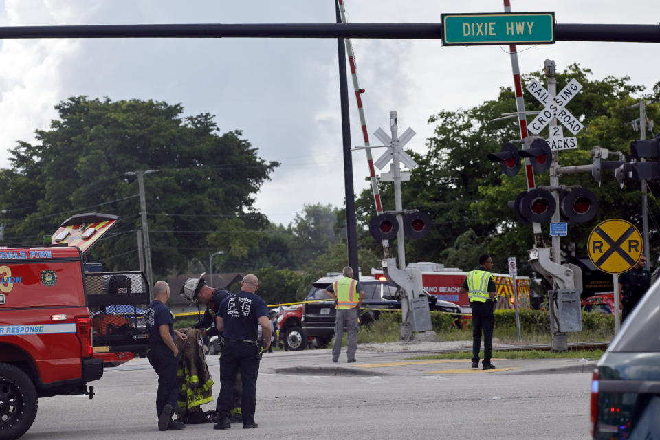 First responders work the scene after a Broward Sheriff's Office Fire-Rescue helicopter crashed in Pompano Beach near Fort Lauderdale, Fla., on Monday, Aug. 28. (Amy Beth Bennett/South Florida Sun-Sentinel via AP)