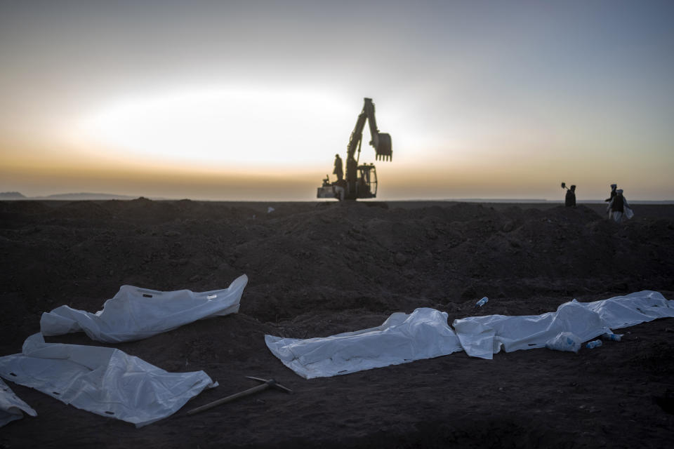 Afghans bury hundreds of people killed in an earthquake to a burial site, outside a village in Zenda Jan district in Herat province, western of Afghanistan, Monday, Oct. 9, 2023. Saturday's deadly earthquake killed and injured thousands when it leveled an untold number of homes in Herat province. (AP Photo/Ebrahim Noroozi)