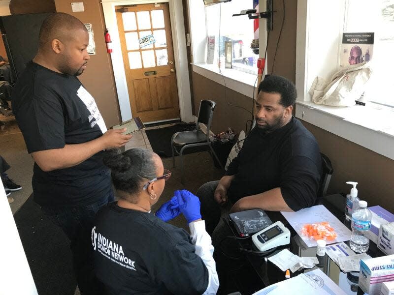 A man receives health tests at a past Indiana Black Barbershop Health Initiative event in South Bend.