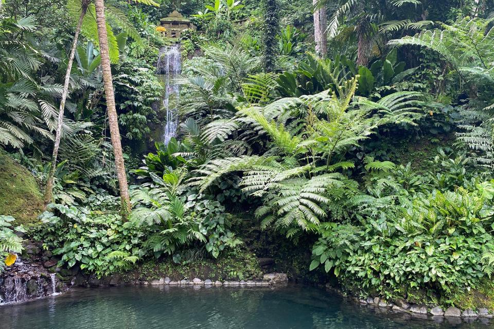 A waterfall flowing from The Source water temple at Como Shambhala Estate