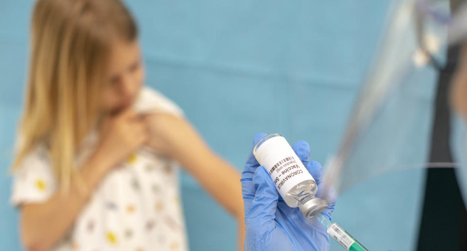 Doctor injecting Covid vaccination on child arm. Source: Getty Images 