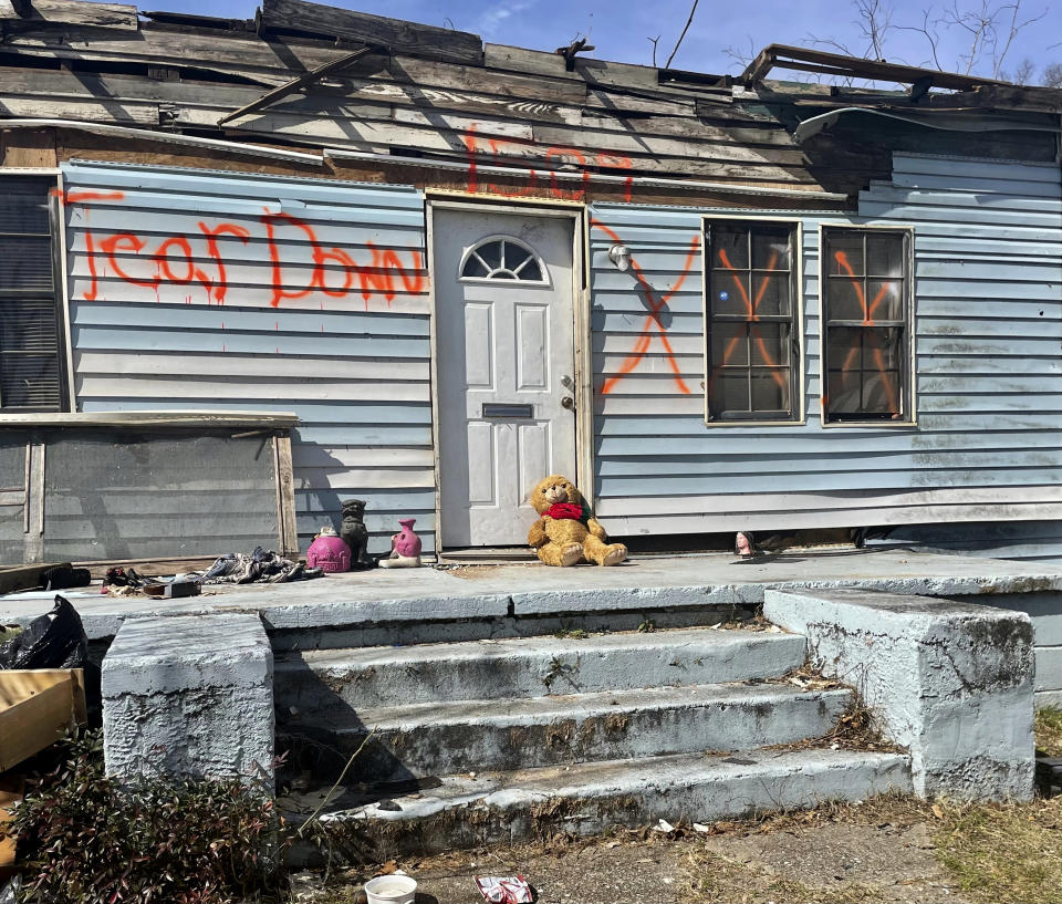 A home damaged by last month's tornado stands with a message indicating it will be torn down in Selma, Ala., Tuesday, Feb. 14, 2023. A month after a tornado ravaged historic Selma, a city etched in the history of the civil rights movement, residents and city officials say they are bracing for a long recovery. (AP Photo/Kim Chandler)