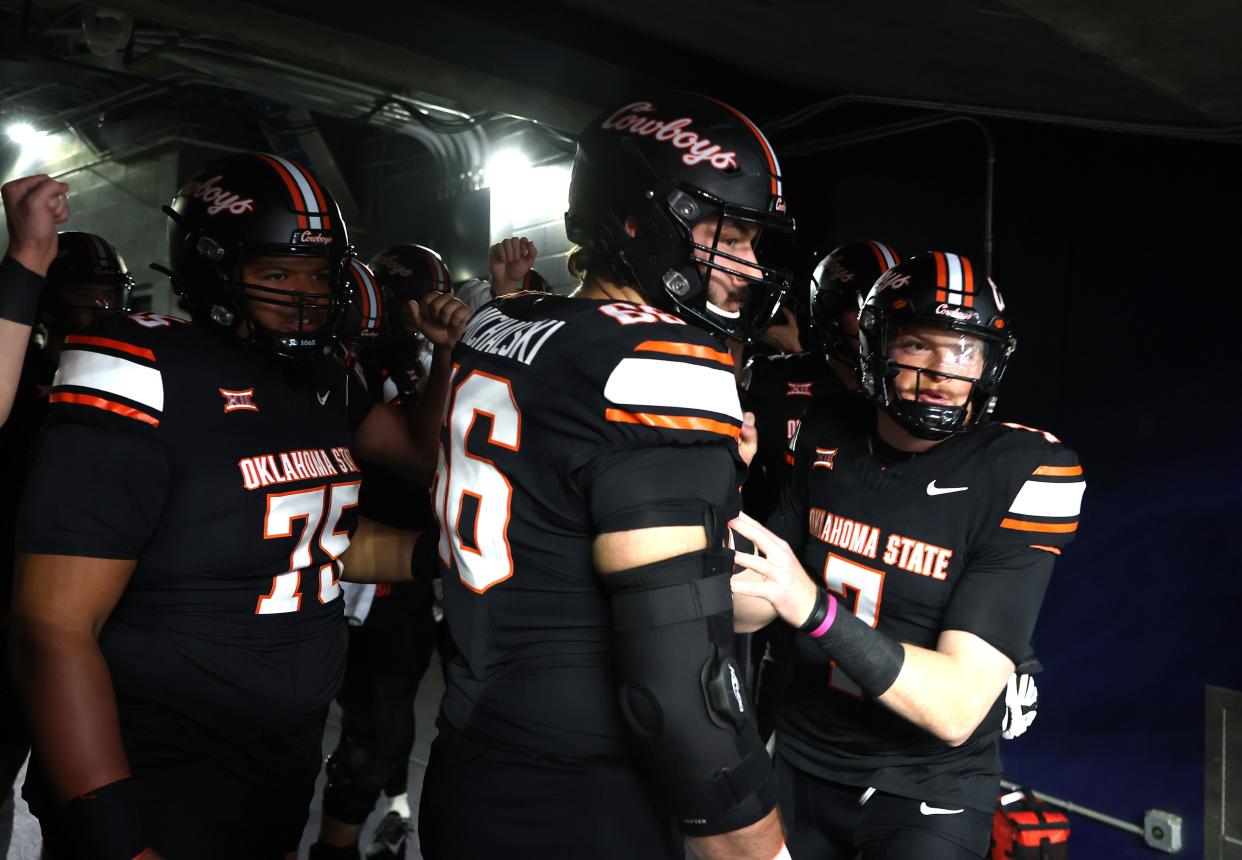 Oklahoma State's Alan Bowman (7) leads the team out before the Big 12 Football Championship game between the Oklahoma State University Cowboys and the Texas Longhorns at the AT&T Stadium in Arlington, Texas, Saturday, Dec. 2, 2023.