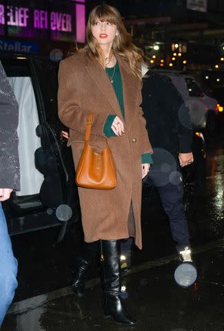 <p>Gotham/GC Images</p> Swift wore a green sweater dress to Electric Lady Studios on Tuesday