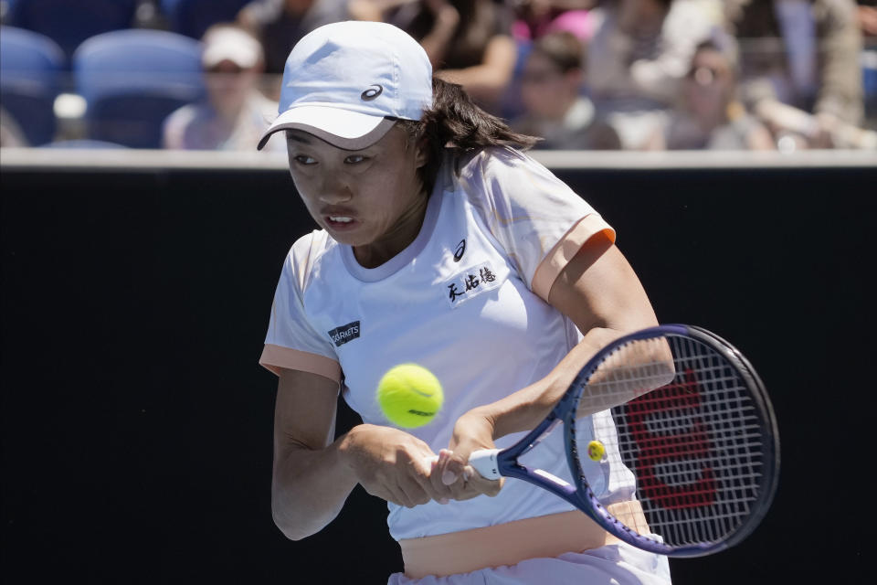 Zhang Shuai of China plays a backhand return to Karolina Pliskova of the Czech Republic during their fourth round match at the Australian Open tennis championship in Melbourne, Australia, Monday, Jan. 23, 2023. (AP Photo/Dita Alangkara)