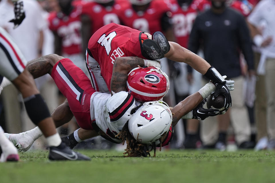 Ball State defensive back Jordan Riley (3) breaks up a pass indented for Georgia tight end Oscar Delp (4) in the first half of an NCAA college football game Saturday, Sept. 9, 2023, in Athens, Ga. (AP Photo/John Bazemore)