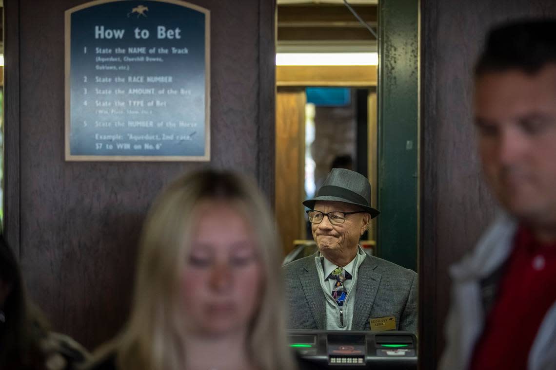 Eddie Riddle, a mutual clerk, waits to to take bets on the opening day of the Keeneland Fall Meet on Friday.