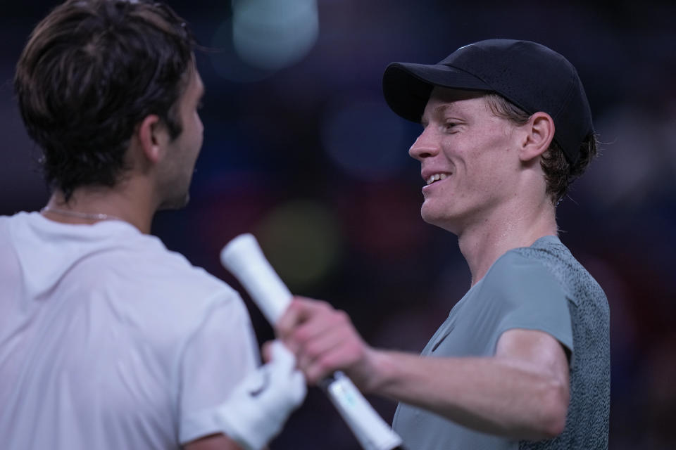 Jannik Sinner of Italy, right, is congratulated by Tomas Martin Etcheverry of Argentina after winning in the men's singles third round match in the Shanghai Masters tennis tournament at Qizhong Forest Sports City Tennis Center in Shanghai, China, Sunday, Oct. 6, 2024. (AP Photo/Andy Wong)