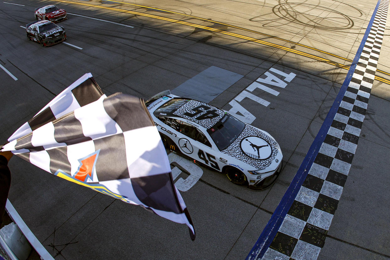 TALLADEGA, ALABAMA - APRIL 21: Tyler Reddick, driver of the #45 Jordan Brand Toyota, takes the checkered flag to win the NASCAR Cup Series GEICO 500 at Talladega Superspeedway on April 21, 2024 in Talladega, Alabama. (Photo by Sean Gardner/Getty Images)