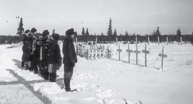 In this photo presented at the Truth and Reconciliation Commision, residential school students are seen at the Roman Catholic cemetery in Fort George, Que. Fort George was home to the province's first residential schools. ( Truth and Reconciliation Commission/Deschâtelets Archives - image credit)