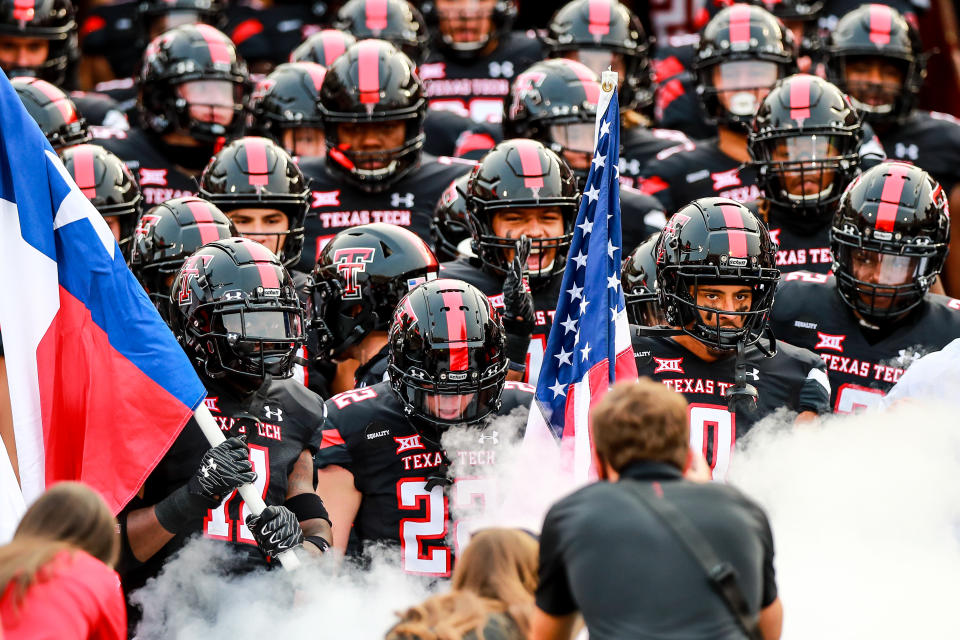 LUBBOCK, TEXAS - SEPTEMBER 12: Defensive back Eric Monroe #11, receiver Sterling Galban #22, and receiver Seth Collins #0 of the Texas Tech Red Raiders lead their teammates onto the field before the college football game against the Houston Baptist Huskies on September 12, 2020 at Jones AT&T Stadium in Lubbock, Texas. (Photo by John E. Moore III/Getty Images)