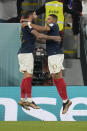 France's Kylian Mbappe, right, celebrates with his teammate Theo Hernandez after scoring his side's first goal during the World Cup group D soccer match between France and Denmark, at the Stadium 974 in Doha, Qatar, Saturday, Nov. 26, 2022. (AP Photo/Christophe Ena)