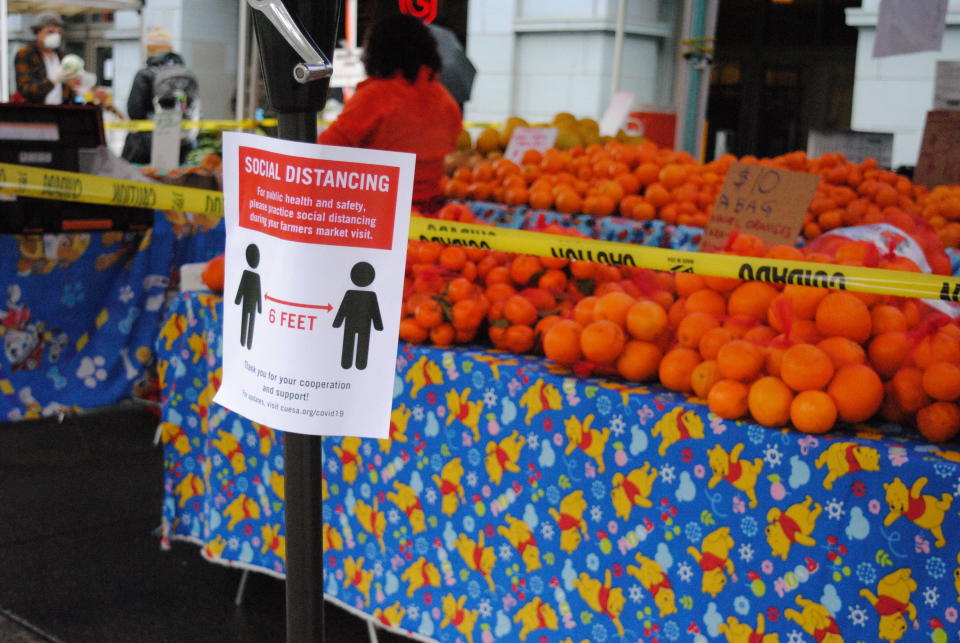 Caution tape prevents shoppers from touching the produce at the Ferry Plaza Farmers Market in San Francisco. (Photo: Ferry Plaza Farmers Market)