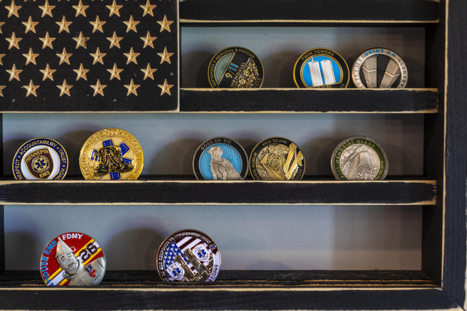 Image: A collection of 9/11 memorial challenge coins hang on a wall of the home of Jennifer Waddleton on Sept. 9, 2021 in Lehigh Acres, Fla. (Saul Martinez for NBC News)