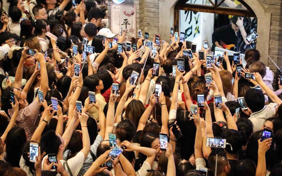 Fans watch the boy band Modern Brothers in Dandong, China, in 2018