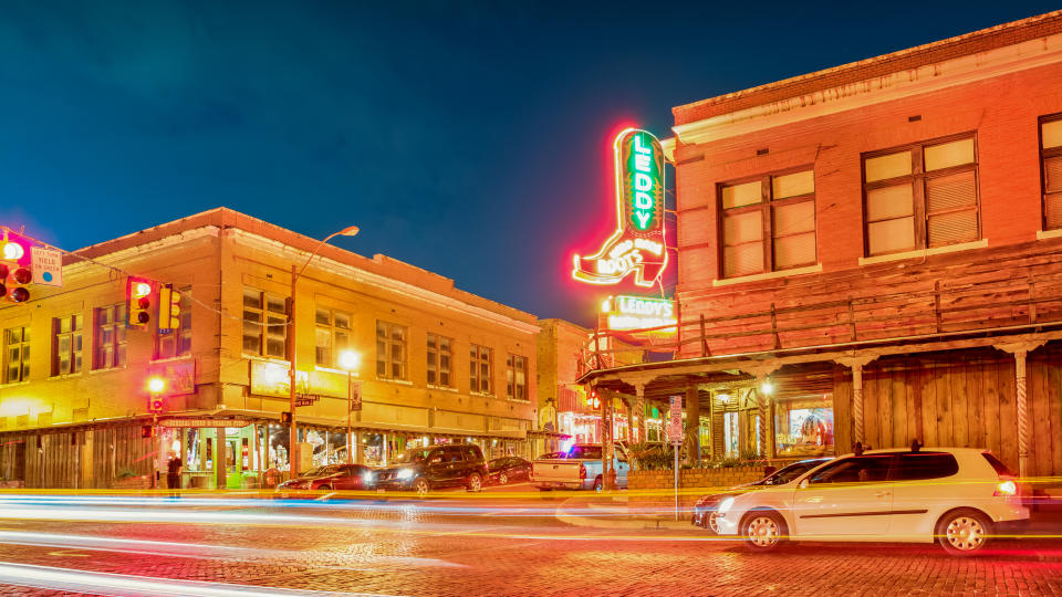 Cars wait at stoplight next to Leddy's Boot store at the landmark Fort Worth Stockyards in Fort Worth, Texas, USA.