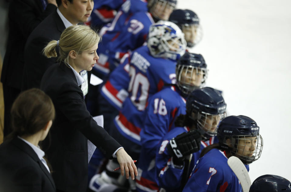 Combined Koreas head coach Sarah Murray (L) watches a women’s ice hockey friendly game between her team and Sweden at Seonhak International Ice Rink in Incheon, South Korea. (AP)