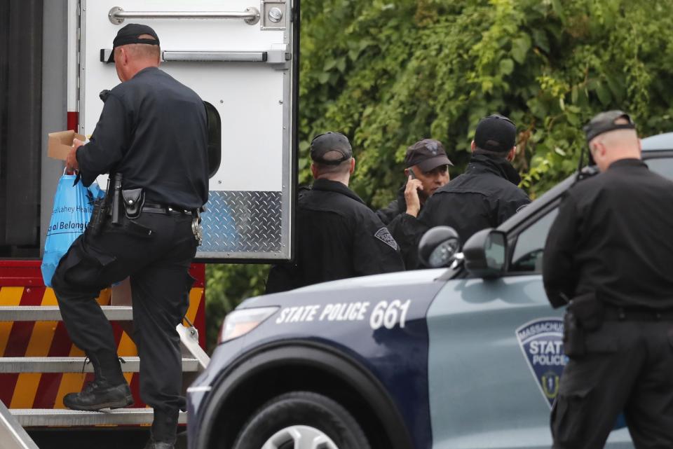 Police work on in the area of an hours long standoff with a group of armed men that partially shut down interstate 95, Saturday, July 3, 2021, in Wakefield, Mass. Massachusetts state police say 11 suspects have been taken into custody. (AP Photo/Michael Dwyer)