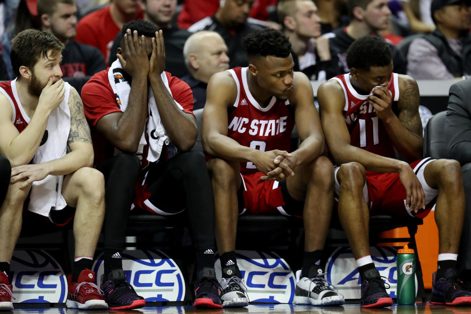 CHARLOTTE, NORTH CAROLINA - MARCH 14: Teammates Torin Dorn #2 and Markell Johnson #11 of the North Carolina State Wolfpack react to their 76-56 loss against the Virginia Cavaliers in the quarterfinal round of the 2019 Men's ACC Basketball Tournament at Spectrum Center on March 14, 2019 in Charlotte, North Carolina. (Photo by Streeter Lecka/Getty Images)