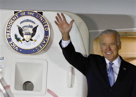 U.S. Vice President Joe Biden waves upon his arrival at Osan Air Base, south of Seoul December 5, 2013. REUTERS/Kim Hong-Ji