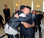 FILE PHOTO: North Korean leader Kim Jong-Un and former NBA basketball player Dennis Rodman (front L) hug in Pyongyang in this undated picture released by North Korea's KCNA news agency on March 1, 2013. REUTERS/KCNA/File Photo