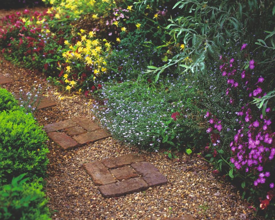 6. Lay bricks in a gravel path for an inexpensive solution