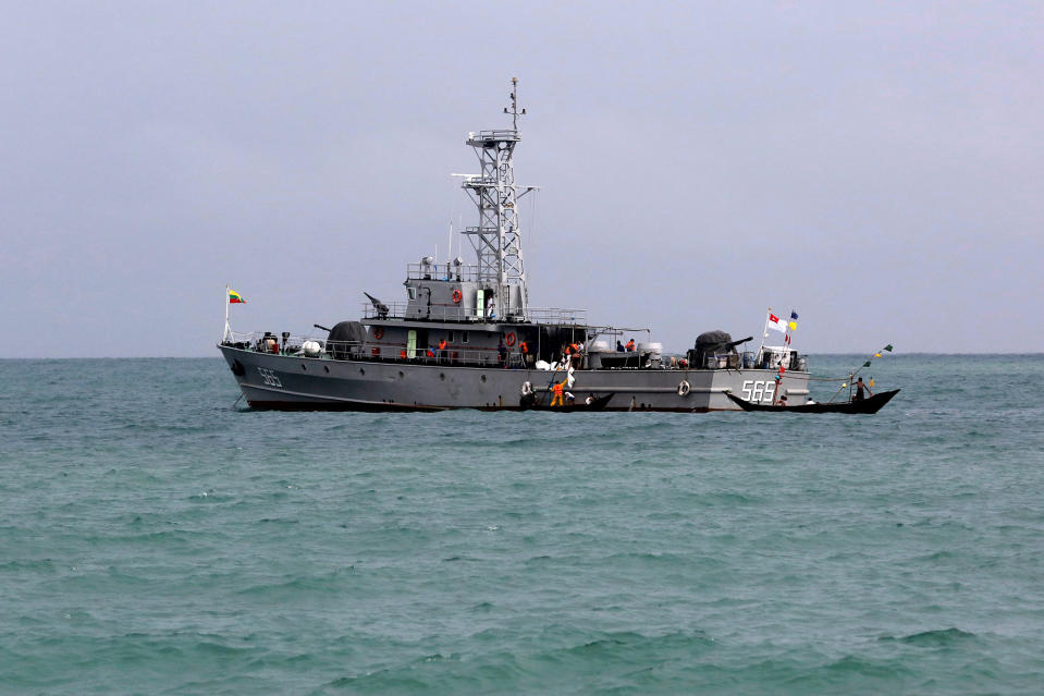 Rescue teams unload bodies from a navy vessel